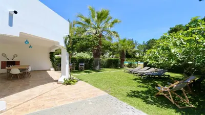 a backyard with benches and tables and trees at Fig Villa- CleverDetails, Sleep 8, Pool, Children Playground, Ténis court in Vilamoura