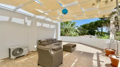 an outdoor living room with a couch and a heater at Fig Villa- CleverDetails, Sleep 8, Pool, Children Playground, Ténis court in Vilamoura
