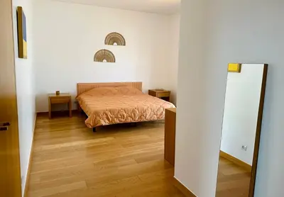 a bedroom with a bed and a mirror at Vila Elvia in Albufeira