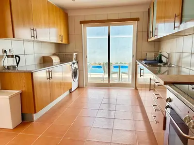a large kitchen with a view of the ocean at Vila Elvia in Albufeira