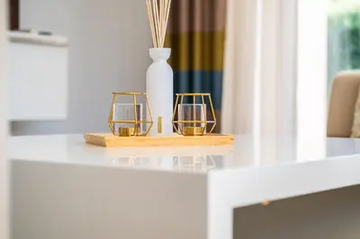 a table with two candles and a vase on it at Villas Novochoro - Small Garden by DreamvillasAlbufeira in Albufeira