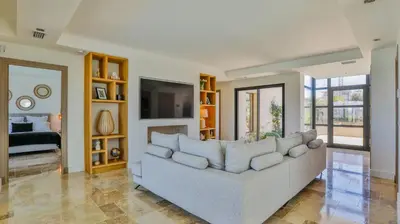 a living room with a couch and a television at Brand New Waterfront Villa with pool in Faro