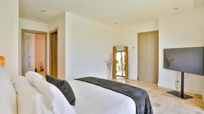 a living room with a white couch and a flat screen tv at Brand New Waterfront Villa with pool in Faro