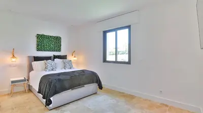 a white bedroom with a bed and a window at Brand New Waterfront Villa with pool in Faro