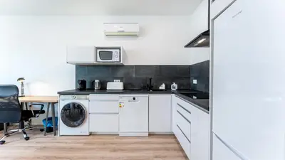 a kitchen with a washing machine and a microwave at Modern Retreat 2 in Faro by Lovelystay in Faro