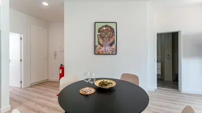 a dining room with a black table and chairs at Modern Retreat 2 in Faro by Lovelystay in Faro