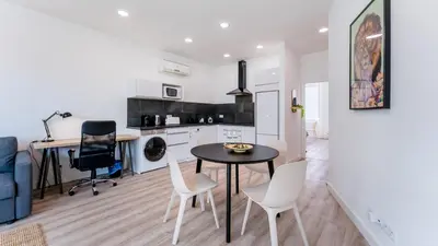 a kitchen and dining room with a table and chairs at Modern Retreat 2 in Faro by Lovelystay in Faro