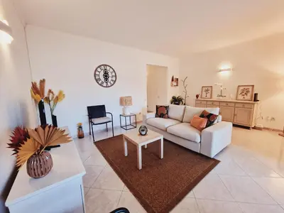 a living room with a couch and a table at Casa Kari in Albufeira