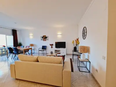 a living room with a couch and a table at Casa Kari in Albufeira