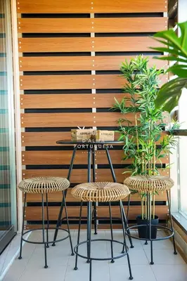 a table and two chairs in front of a wooden wall at Apartment Terracota By Dalma Portuguesa in Albufeira