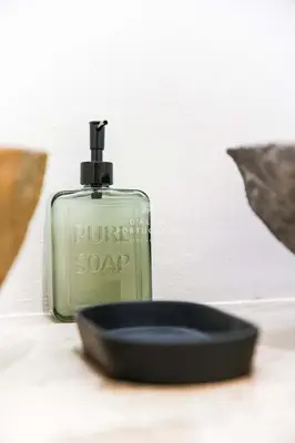 a bottle of soap sitting next to a soap dish at Apartment Terracota By Dalma Portuguesa in Albufeira