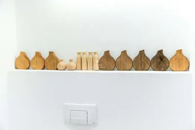 a row of wooden vases sitting on a shelf at Apartment Terracota By Dalma Portuguesa in Albufeira