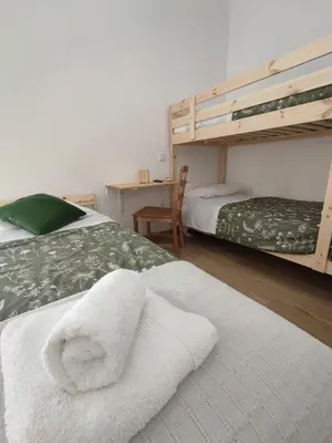 a bedroom with two bunk beds with towels on the bed at Casa do Belé in Faro