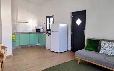 a living room with a couch and a refrigerator at Casa do Belé in Faro