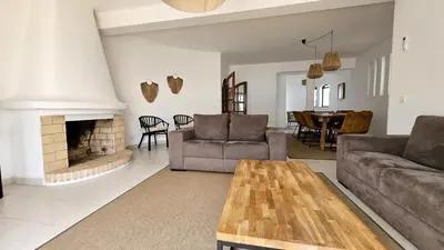 a living room with a couch and a fireplace at Casa Catarina in Albufeira