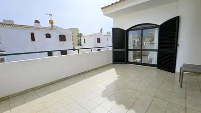 an empty balcony of a house with a glass door at Casa Catarina in Albufeira