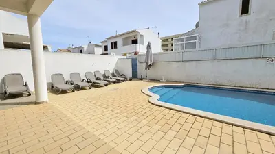 a patio with chairs and a swimming pool at Casa Catarina in Albufeira