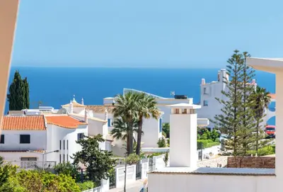 a tennis court in front of a building at BnB Homes Ocean view Apartment with comfortable Terrace, 2 Swimming pools & Tennis court in Albufeira