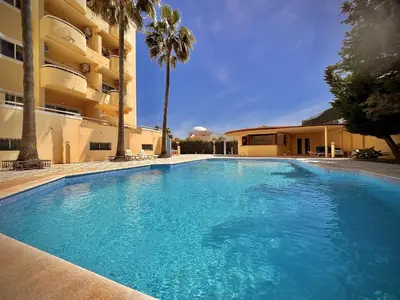 a large blue swimming pool next to a building at Albufeira Marina Sol With Pool by Homing in Albufeira