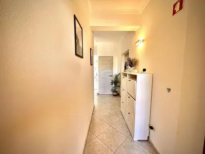 a hallway leading to a kitchen with a refrigerator at Albufeira Marina Sol With Pool by Homing in Albufeira