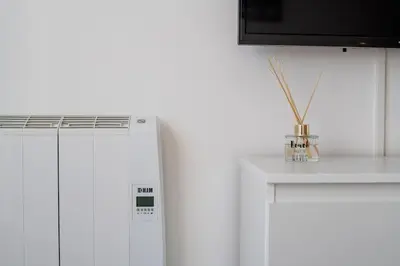 a kitchen with a white refrigerator and a counter at Blife Allya private rooms in Faro