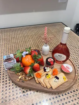 a plate of food with fruit and a bottle of syrup at Casa da vila in Faro