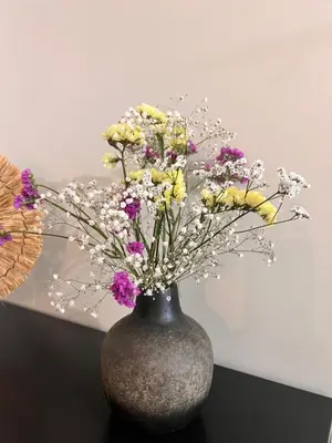 a vase filled with flowers sitting on a table at Casa da vila in Faro