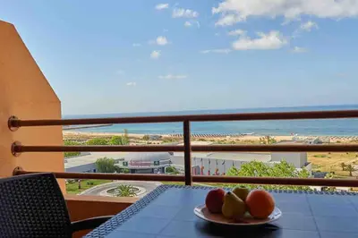 a table with a plate of fruit on a balcony at Estúdio Vista Mar em Vilamoura in Quarteira