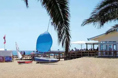a beach with a large blue ball on the sand at Estúdio Vista Mar em Vilamoura in Quarteira