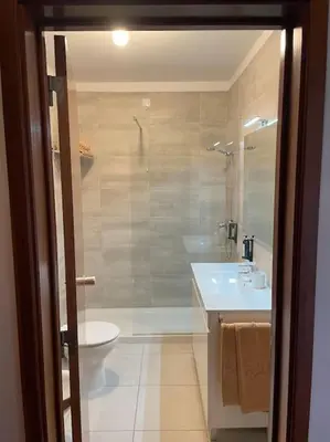 a bathroom with a tub and a sink and a toilet at Estúdio Vista Mar em Vilamoura in Quarteira