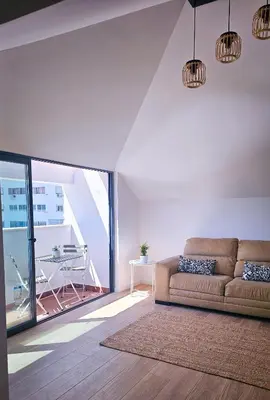 a living room with a couch and a table at Carmo City Center 3 in Faro
