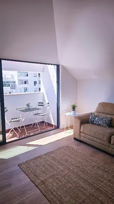 a living room with a couch and a table at Carmo City Center 3 in Faro
