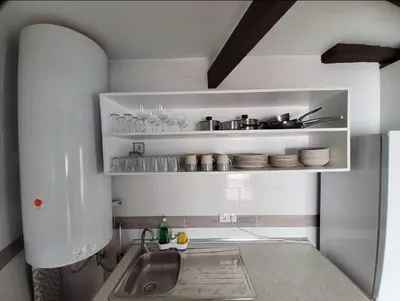 a kitchen with a sink and a shelf with dishes at Blife Castelya private rooms in Faro