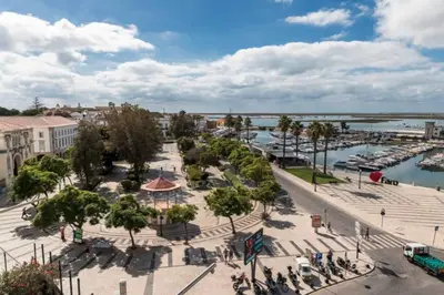 an aerial view of a city with a marina at Blife Castelya private rooms in Faro