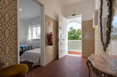 a room with a door leading to a bedroom at Blife Faya private rooms in Faro