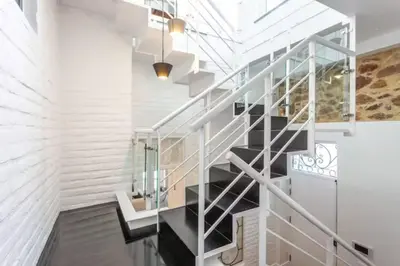 a staircase in a house with a glass railing at Blife Galya private rooms in Faro