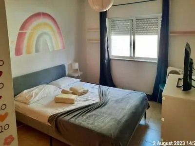 a bedroom with a bed with a rainbow on the wall at Blife Macaya private rooms in Monte Negro