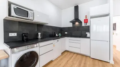 a kitchen with a washing machine and a microwave at Modern Retreat 1 in Faro by Lovelystay in Faro