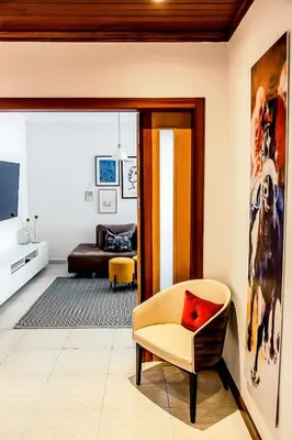 a living room with a chair and a couch at Casa Gulbenkian - Modern apartment by HD in Faro