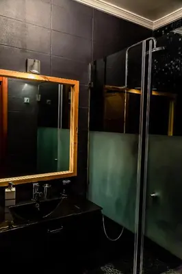 a bathroom with a shower and a sink and a mirror at Casa Gulbenkian - Modern apartment by HD in Faro