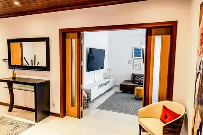 a living room with a table and a mirror at Casa Gulbenkian - Modern apartment by HD in Faro