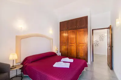 a bedroom with a red bed with a red blanket at Casa Sol in Quarteira