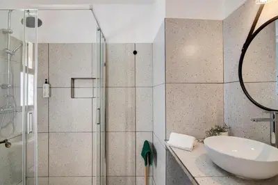 a bathroom with a sink and a shower at Casa Sol in Quarteira
