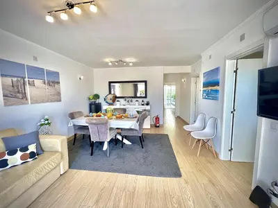 a living room with a table and a dining room at Vilamoura Eden Villa With Pool by Homing in Vilamoura