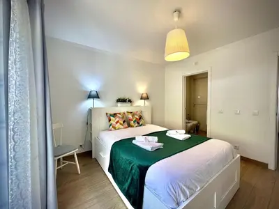 a bedroom with a bed with a green blanket at Vilamoura Eden Villa With Pool by Homing in Vilamoura
