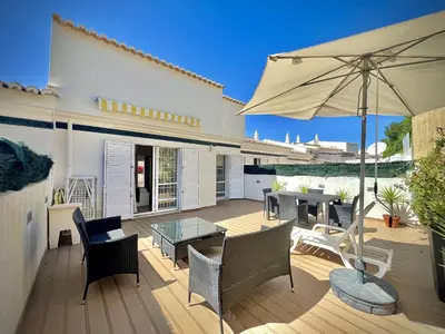a patio with a table and an umbrella at Vilamoura Eden Villa With Pool by Homing in Vilamoura