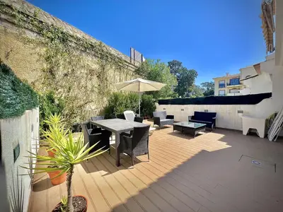 a patio with a table and chairs and an umbrella at Vilamoura Eden Villa With Pool by Homing in Vilamoura