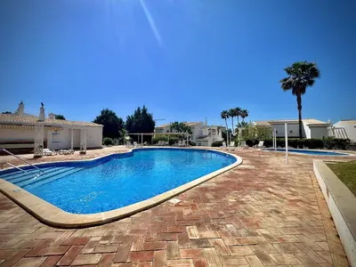 a swimming pool in front of a house at Vilamoura Eden Villa With Pool by Homing in Vilamoura