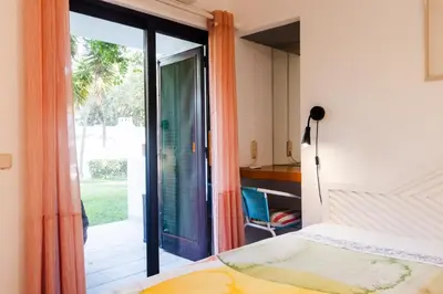 a bedroom with a bed with two surfboards on it at Acolhedora Vila 371, 3 quartos, Balaia Golf Village in Albufeira