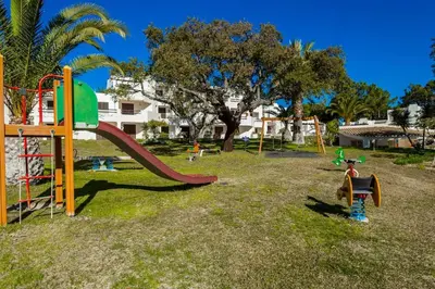 a view of a beach with boats on the shore at Acolhedora Vila 371, 3 quartos, Balaia Golf Village in Albufeira